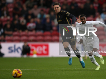 Isaiah Jones of Middlesbrough has his shirt pulled by Luis Binks of Coventry City during the Sky Bet Championship match between Middlesbroug...