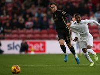 Isaiah Jones of Middlesbrough has his shirt pulled by Luis Binks of Coventry City during the Sky Bet Championship match between Middlesbroug...