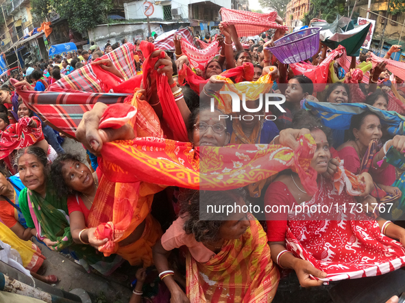 Indian devotees collect holy rice during the Annakut Utsav (Govardhan Puja) at Madan Mohon Mandir in Kolkata, India, on November 2, 2024. Pe...