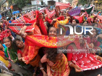 Indian devotees collect holy rice during the Annakut Utsav (Govardhan Puja) at Madan Mohon Mandir in Kolkata, India, on November 2, 2024. Pe...