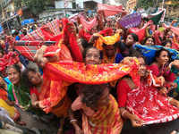 Indian devotees collect holy rice during the Annakut Utsav (Govardhan Puja) at Madan Mohon Mandir in Kolkata, India, on November 2, 2024. Pe...