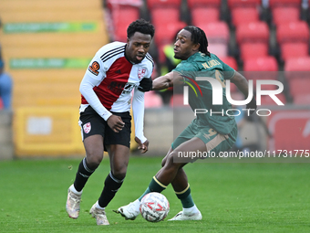 Timi Odusina (5 Woking) is challenged by Dan Nlundulu (9 Cambridge United) during the FA Cup First Round match between Woking and Cambridge...