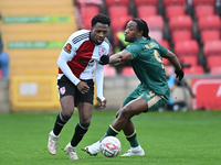 Timi Odusina (5 Woking) is challenged by Dan Nlundulu (9 Cambridge United) during the FA Cup First Round match between Woking and Cambridge...