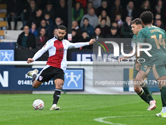 Dennon Lewis (11 Woking) shoots during the FA Cup First Round match between Woking and Cambridge United at the Kingfield Stadium in Woking,...