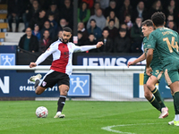 Dennon Lewis (11 Woking) shoots during the FA Cup First Round match between Woking and Cambridge United at the Kingfield Stadium in Woking,...