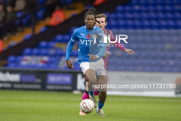 Tayo Adaramola, number 33 of Stockport County F.C., is in action during the FA Cup First Round match between Stockport County and Forest Gre...