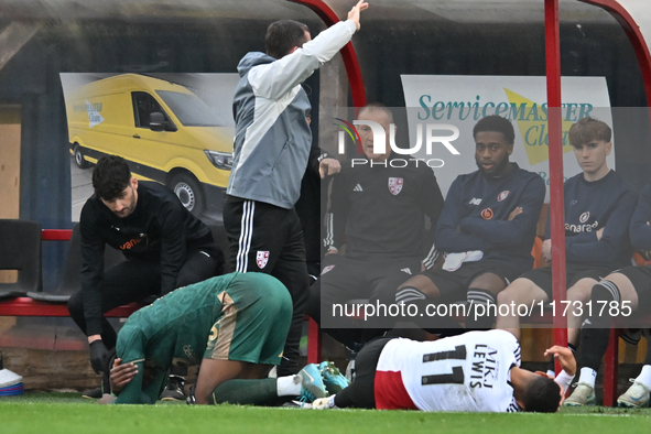 Jubril Okedina (15, Cambridge United) and Dennon Lewis (11, Woking) collide on the touchline during the FA Cup First Round match between Wok...