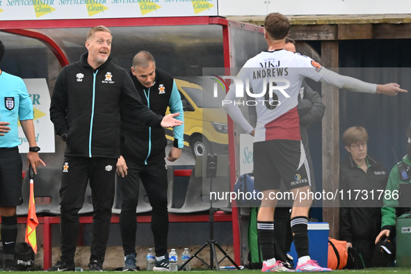 Manager Garry Monk of Cambridge United talks to Jamie Andrews of Woking during the FA Cup First Round match between Woking and Cambridge Uni...