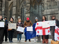 A dozen protesters gather in front of Dom Cathedral to contest the result of the Georgian election and demand a new election in Cologne, Ger...