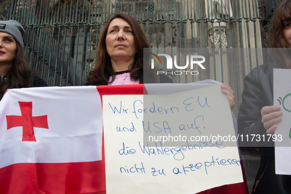 A dozen protesters gather in front of Dom Cathedral to contest the result of the Georgian election and demand a new election in Cologne, Ger...