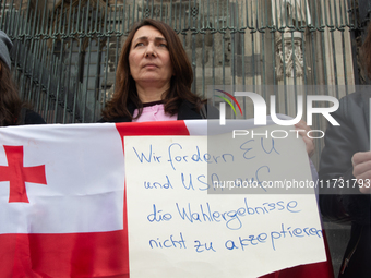 A dozen protesters gather in front of Dom Cathedral to contest the result of the Georgian election and demand a new election in Cologne, Ger...