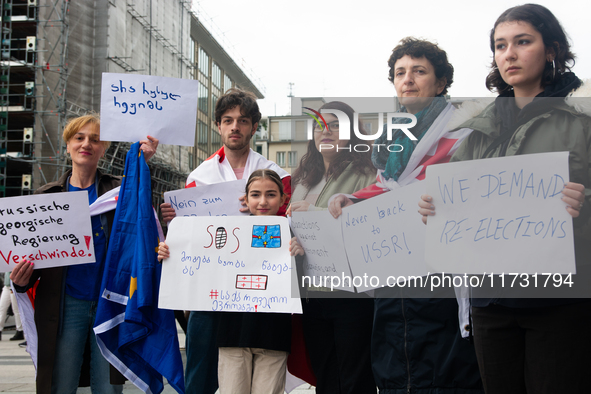 A dozen protesters gather in front of Dom Cathedral to contest the result of the Georgian election and demand a new election in Cologne, Ger...