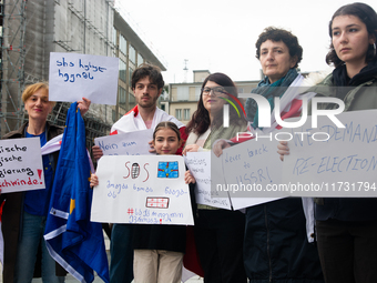 A dozen protesters gather in front of Dom Cathedral to contest the result of the Georgian election and demand a new election in Cologne, Ger...