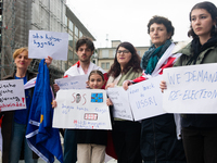 A dozen protesters gather in front of Dom Cathedral to contest the result of the Georgian election and demand a new election in Cologne, Ger...