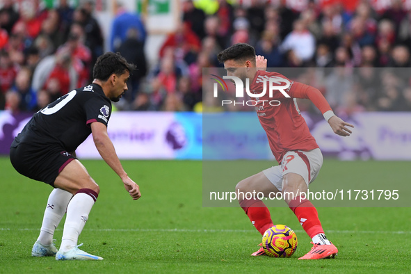 Alex Moreno of Nottingham Forest is under pressure from Lucas Paqueta of West Ham United during the Premier League match between Nottingham...