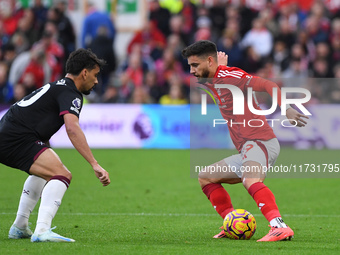 Alex Moreno of Nottingham Forest is under pressure from Lucas Paqueta of West Ham United during the Premier League match between Nottingham...