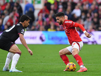 Alex Moreno of Nottingham Forest is under pressure from Lucas Paqueta of West Ham United during the Premier League match between Nottingham...