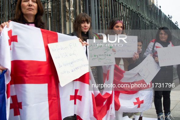 A dozen protesters gather in front of Dom Cathedral to contest the result of the Georgian election and demand a new election in Cologne, Ger...