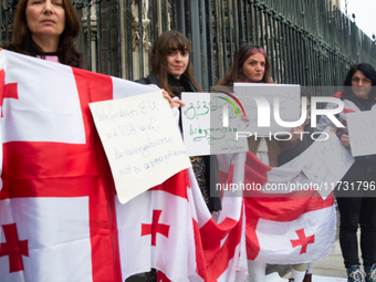 A dozen protesters gather in front of Dom Cathedral to contest the result of the Georgian election and demand a new election in Cologne, Ger...