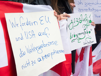 A dozen protesters gather in front of Dom Cathedral to contest the result of the Georgian election and demand a new election in Cologne, Ger...