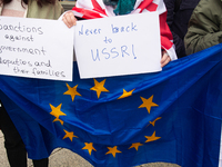 A dozen protesters gather in front of Dom Cathedral to contest the result of the Georgian election and demand a new election in Cologne, Ger...