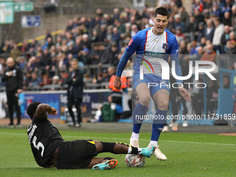 Steven Sessegnon of Wigan Athletic challenges Jon Mellish of Carlisle United during the FA Cup First Round match between Carlisle United and...