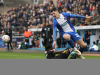 Steven Sessegnon of Wigan Athletic challenges Jon Mellish of Carlisle United during the FA Cup First Round match between Carlisle United and...