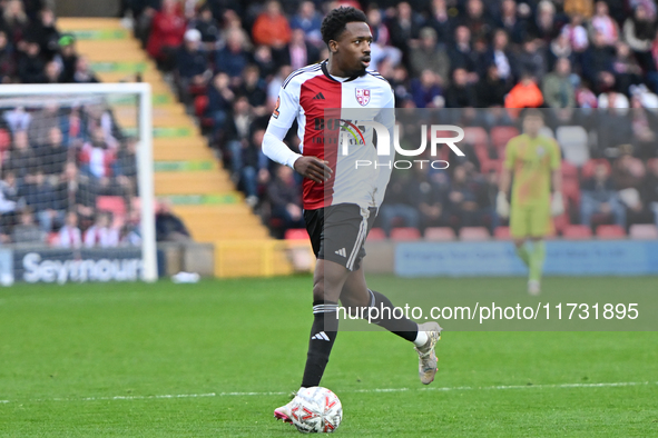 Timi Odusina (5 Woking) controls the ball during the FA Cup First Round match between Woking and Cambridge United at the Kingfield Stadium i...