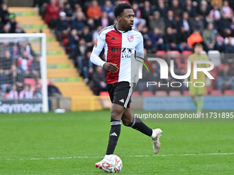 Timi Odusina (5 Woking) controls the ball during the FA Cup First Round match between Woking and Cambridge United at the Kingfield Stadium i...