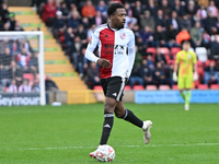 Timi Odusina (5 Woking) controls the ball during the FA Cup First Round match between Woking and Cambridge United at the Kingfield Stadium i...