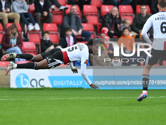 Timi Odusina (5 Woking) is in action during the FA Cup First Round match between Woking and Cambridge United at the Kingfield Stadium in Wok...