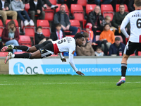 Timi Odusina (5 Woking) is in action during the FA Cup First Round match between Woking and Cambridge United at the Kingfield Stadium in Wok...