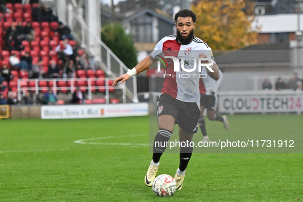 Deon Moore (14 Woking) controls the ball during the FA Cup First Round match between Woking and Cambridge United at the Kingfield Stadium in...