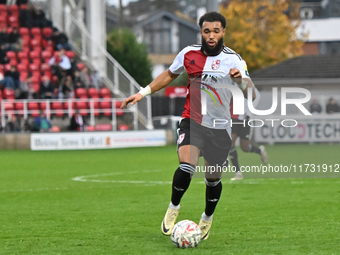 Deon Moore (14 Woking) controls the ball during the FA Cup First Round match between Woking and Cambridge United at the Kingfield Stadium in...