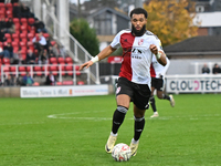 Deon Moore (14 Woking) controls the ball during the FA Cup First Round match between Woking and Cambridge United at the Kingfield Stadium in...