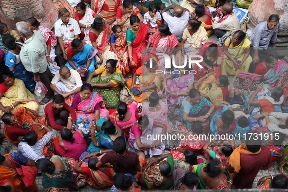 Hindu devotees wait to receive rice as offerings distributed by the temple authority on the occasion of the Annakut festival in Kolkata, Ind...