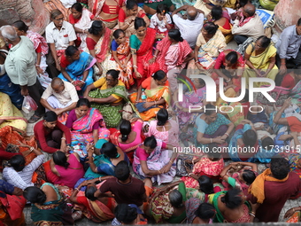 Hindu devotees wait to receive rice as offerings distributed by the temple authority on the occasion of the Annakut festival in Kolkata, Ind...