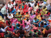 Hindu devotees wait to receive rice as offerings distributed by the temple authority on the occasion of the Annakut festival in Kolkata, Ind...