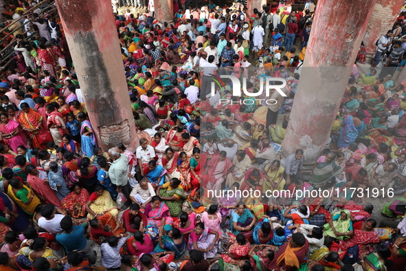 Hindu devotees wait to receive rice as offerings distributed by the temple authority on the occasion of the Annakut festival in Kolkata, Ind...