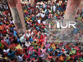 Hindu devotees wait to receive rice as offerings distributed by the temple authority on the occasion of the Annakut festival in Kolkata, Ind...