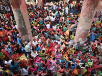 Hindu devotees wait to receive rice as offerings distributed by the temple authority on the occasion of the Annakut festival in Kolkata, Ind...