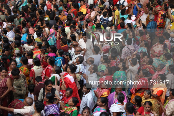 Hindu devotees wait to receive rice as offerings distributed by the temple authority on the occasion of the Annakut festival in Kolkata, Ind...