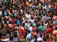 Hindu devotees wait to receive rice as offerings distributed by the temple authority on the occasion of the Annakut festival in Kolkata, Ind...