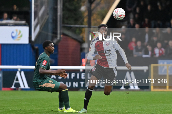 Raheem Conte, 18, from Woking, controls the ball during the FA Cup First Round match between Woking and Cambridge United at the Kingfield St...