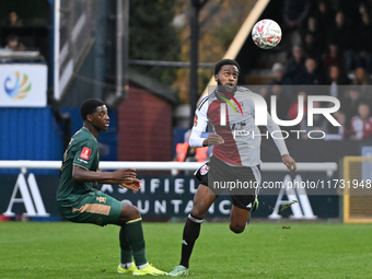 Raheem Conte, 18, from Woking, controls the ball during the FA Cup First Round match between Woking and Cambridge United at the Kingfield St...