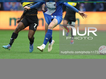 Dion Rankine of Wigan Athletic and Jon Mellish of Carlisle United battle for the ball during the FA Cup First Round match between Carlisle U...