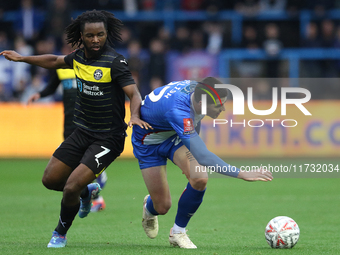 Dion Rankine of Wigan Athletic and Jon Mellish of Carlisle United battle for the ball during the FA Cup First Round match between Carlisle U...