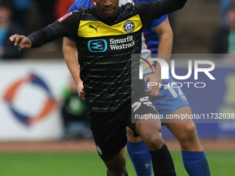 Harrison Neal of Carlisle United challenges Tyrese Francois of Wigan Athletic during the FA Cup First Round match between Carlisle United an...