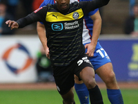 Harrison Neal of Carlisle United challenges Tyrese Francois of Wigan Athletic during the FA Cup First Round match between Carlisle United an...