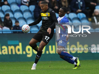 Daniel Adu-Adjei of Carlisle United challenges Toby Sibbick of Wigan Athletic during the FA Cup First Round match between Carlisle United an...